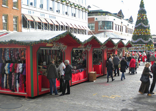 Red and Green LP Custom Storage Shed Vendor Units Being Used At A New York City Christmas Village