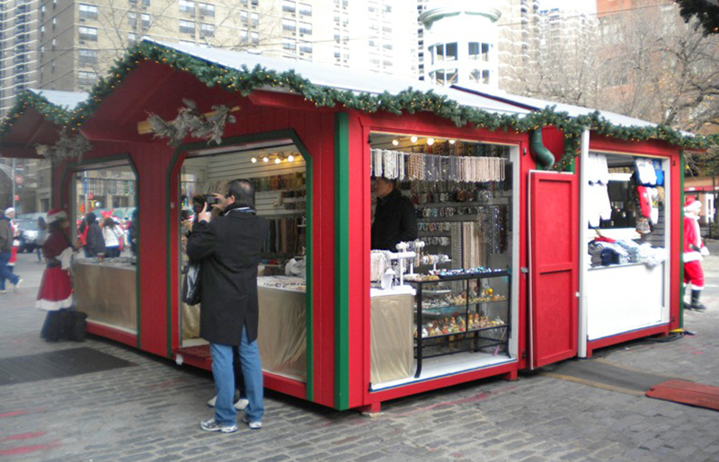 Red and Green LP Custom Storage Shed Vendor Units Being Used At A New York City Christmas Village